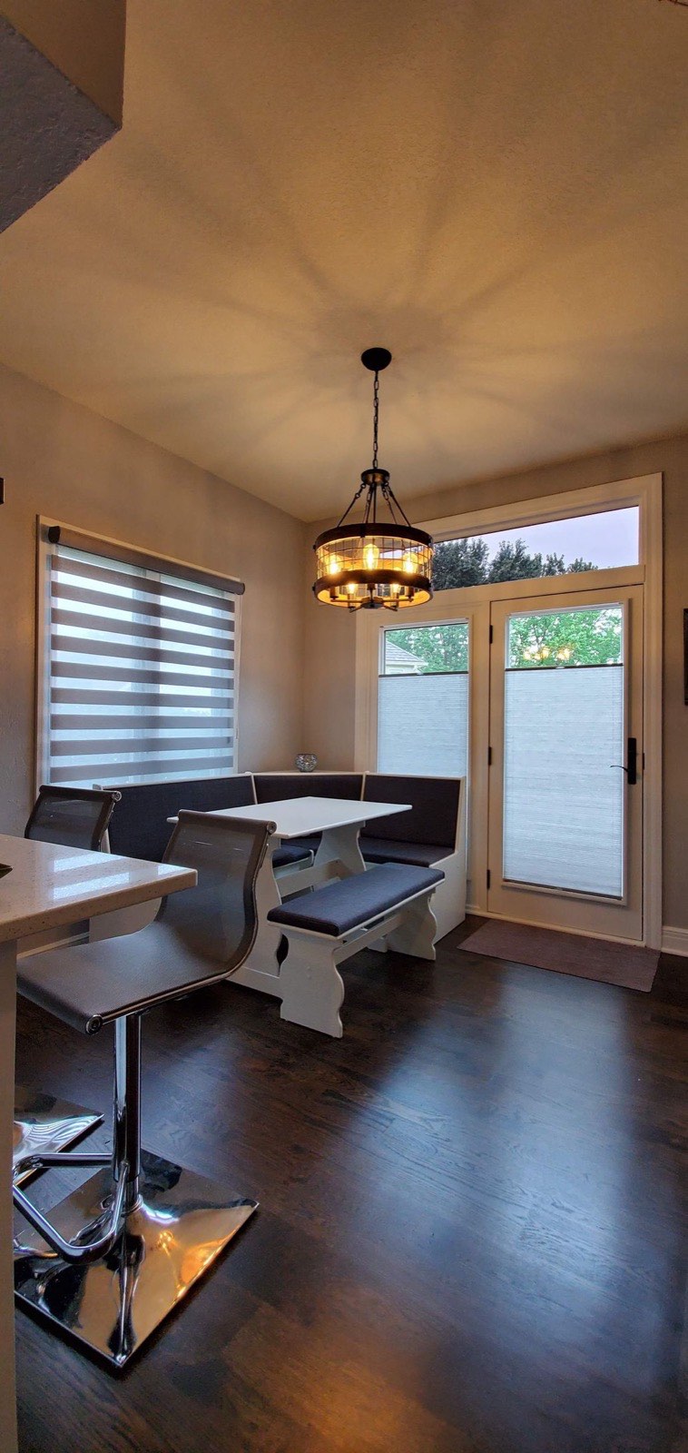 Banded shades in a breakfast nook beside a patio door