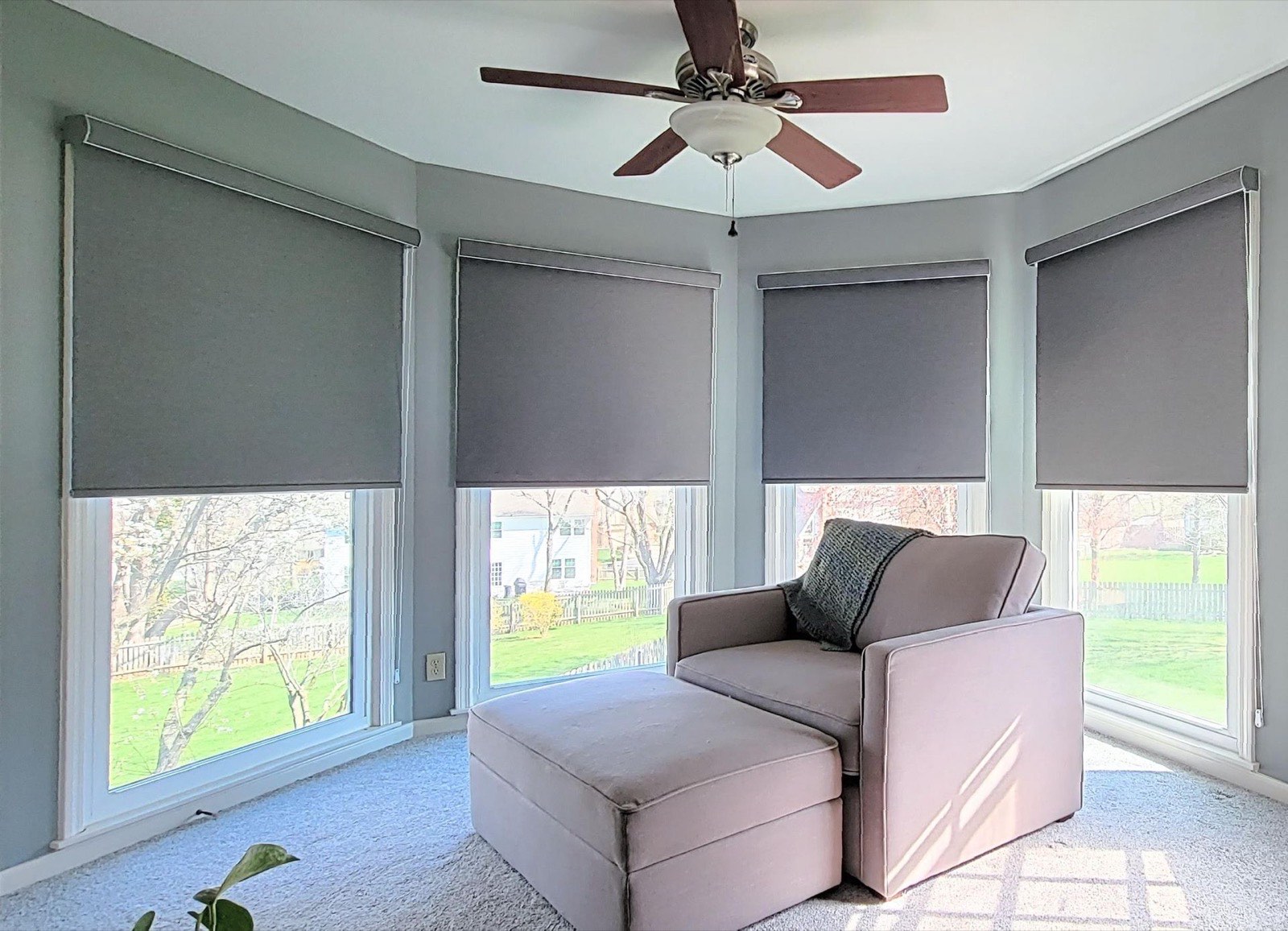 Dual roller shades layered on a bay corner window
